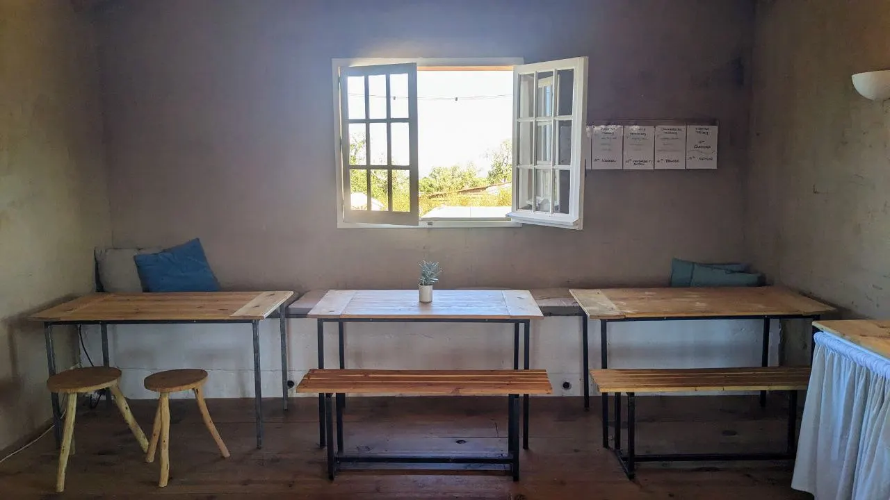 The dining room with wooden tables and an open window