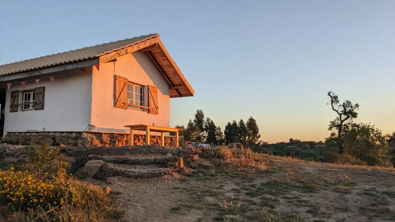 The white community house with wooden shutters in the evening light