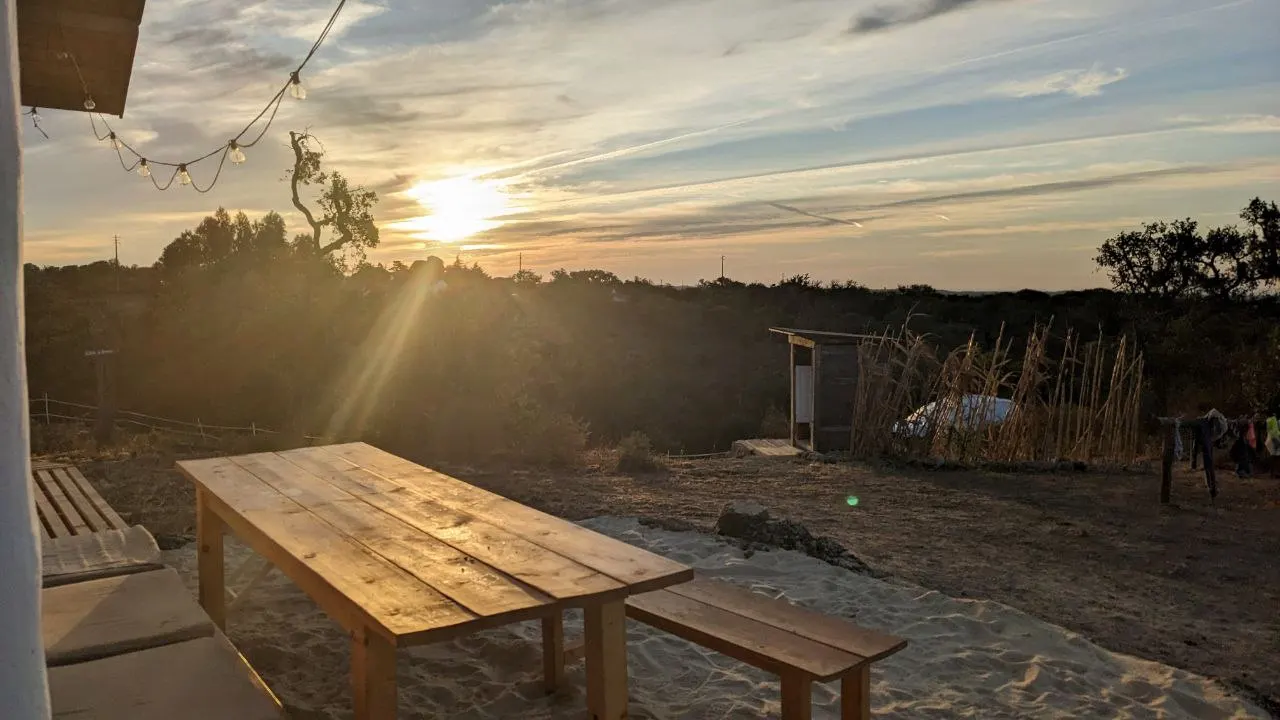 A long wooden table outside at sunset