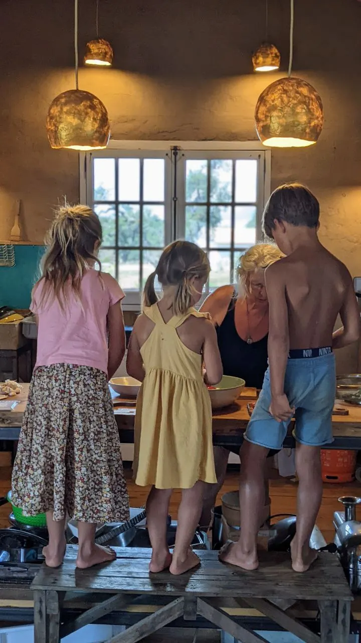 Children cooking together in the Malama community kitchen