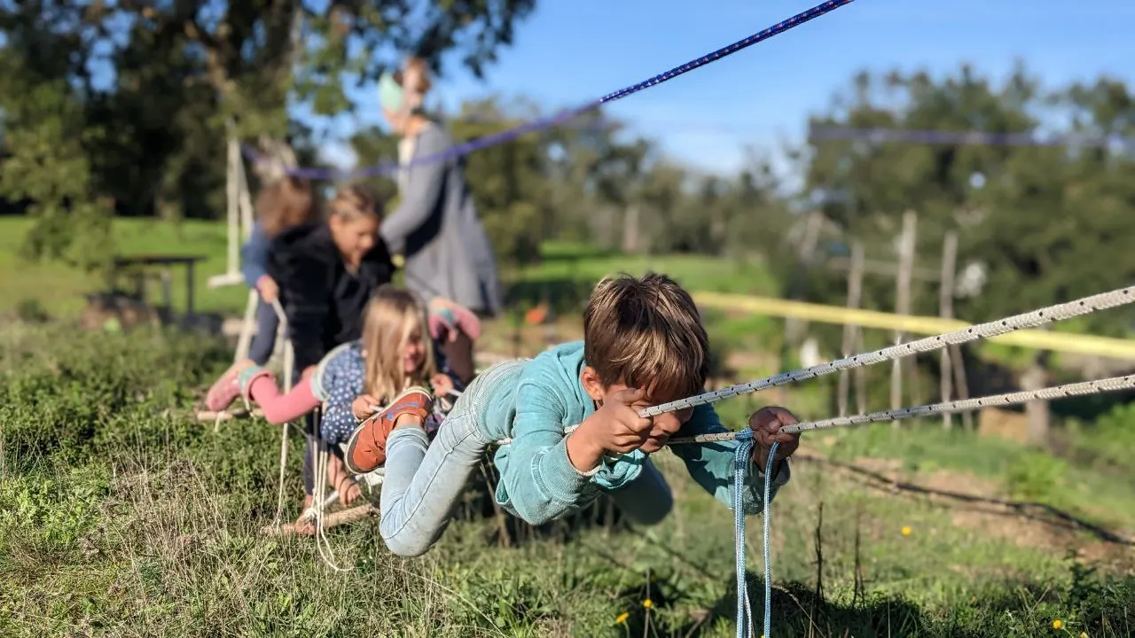 Children playing on ropes in the Malama garden