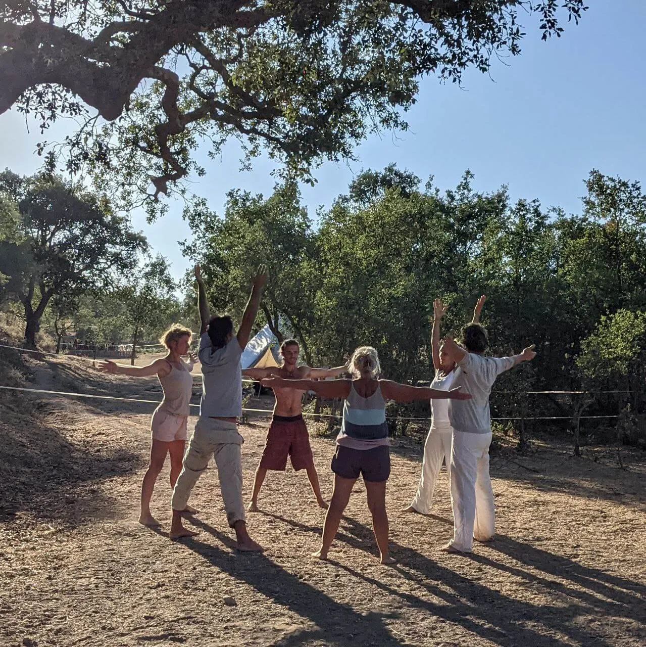 Friends dancing together under the cork oaks